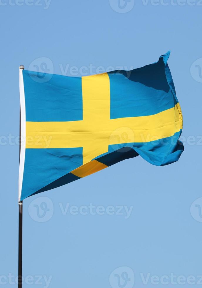 Swedish flag flying on flagpole photo