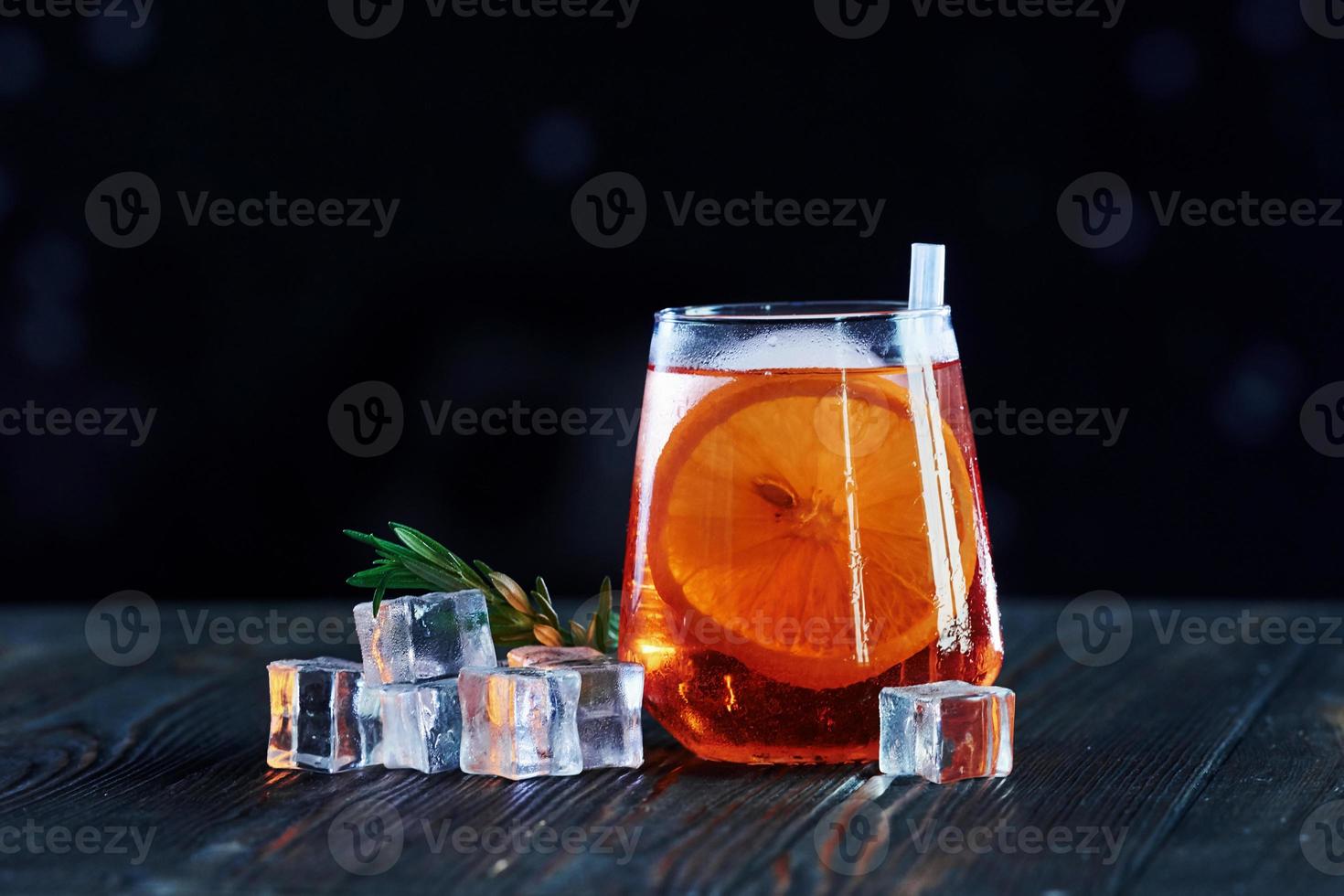 Weekend relaxation. Cocktail is ready. On the wooden table in the night club. Nice lighting photo