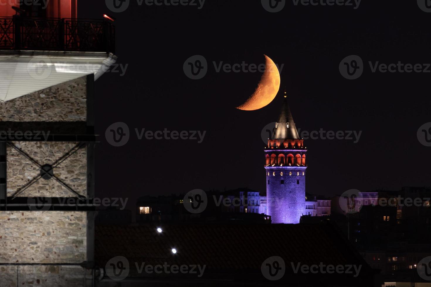 Moonset over Galata Tower in Istanbul, Turkey photo