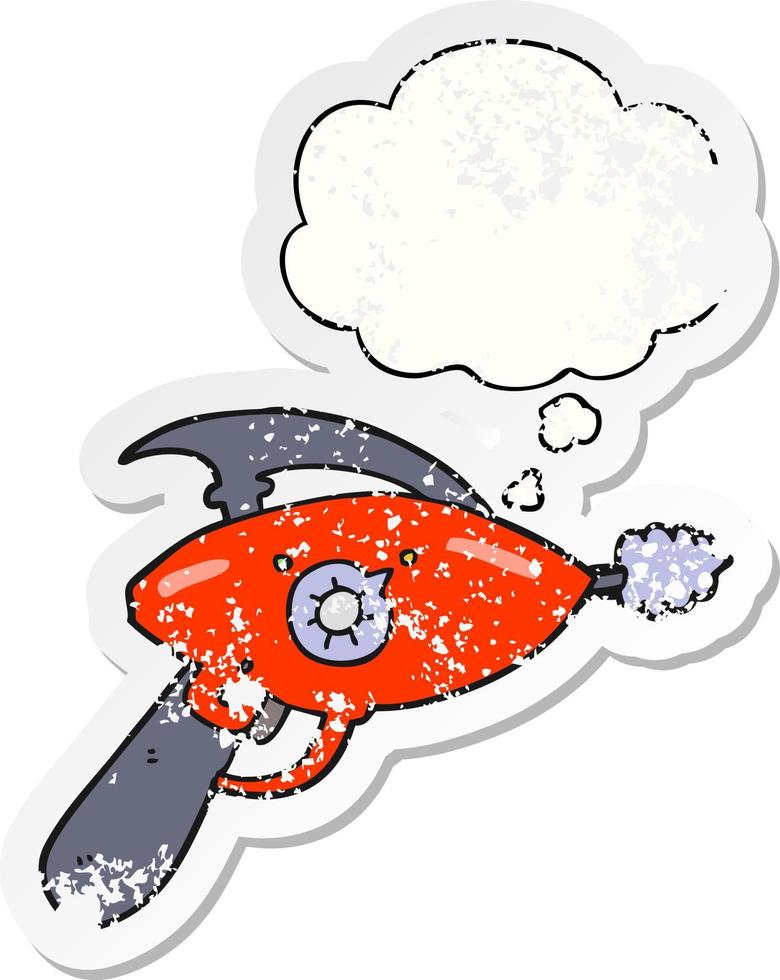 cartoon ray gun and thought bubble as a distressed worn sticker vector