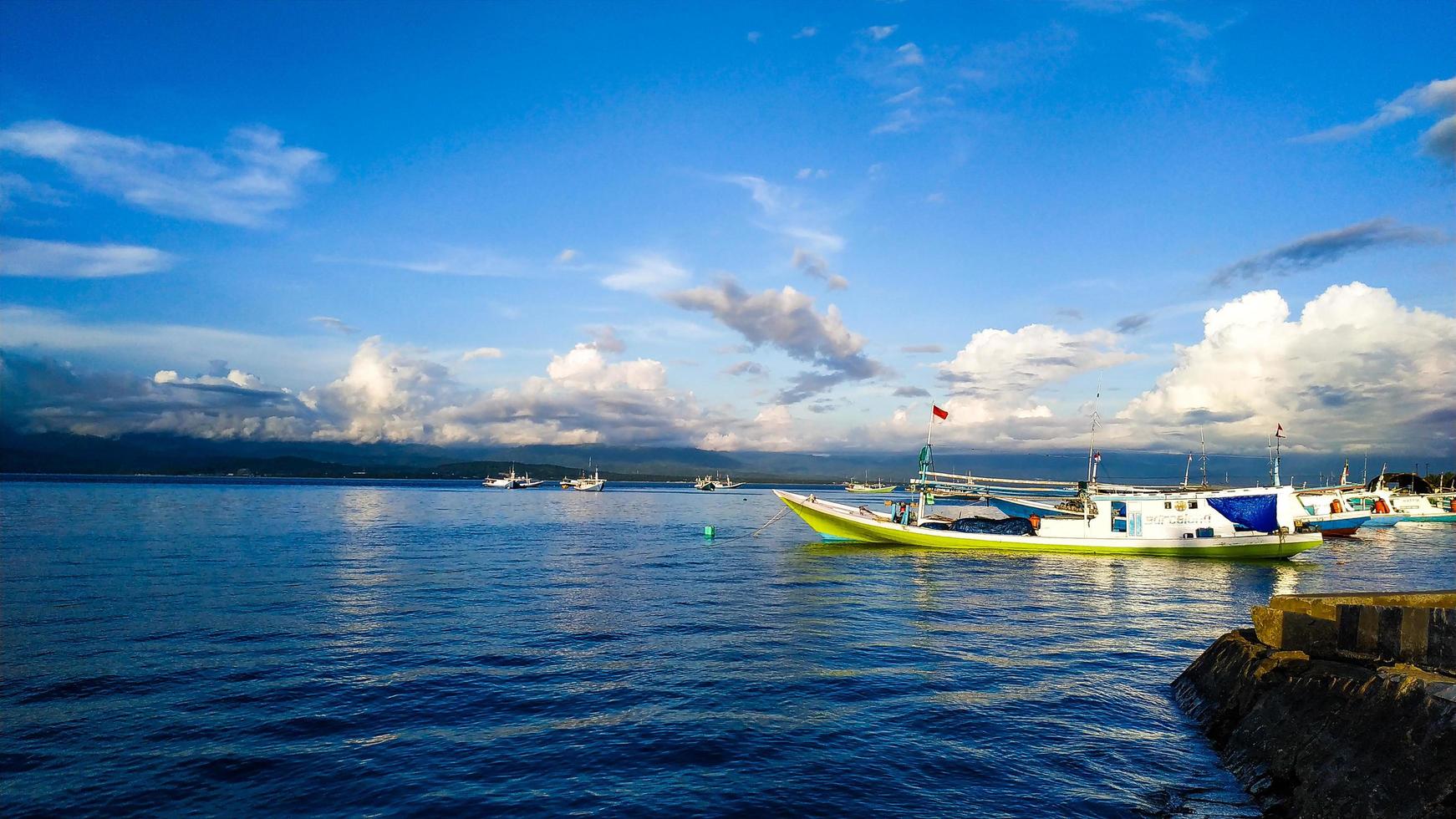 Donggala regency, Indonesia, May 6 2022, Fishing boats in the form of indonesian flagged motorboats leaning on the harbor photo