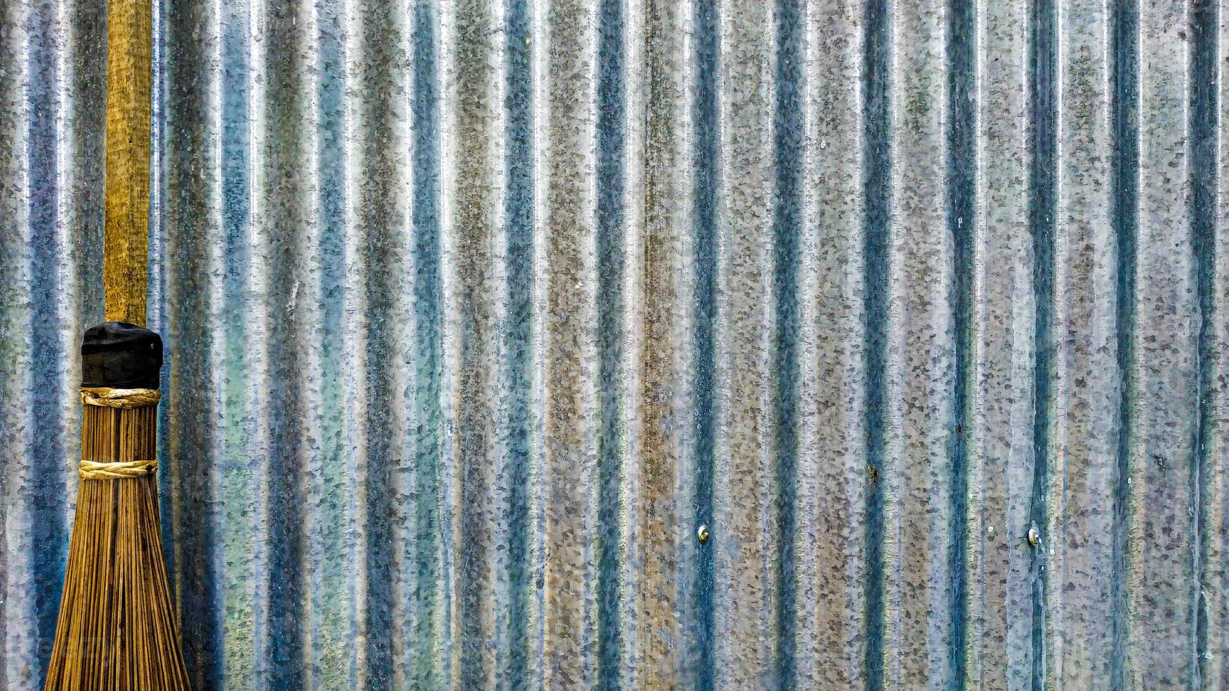 Gray and silver background with empty space made of broom and zinc wall photo