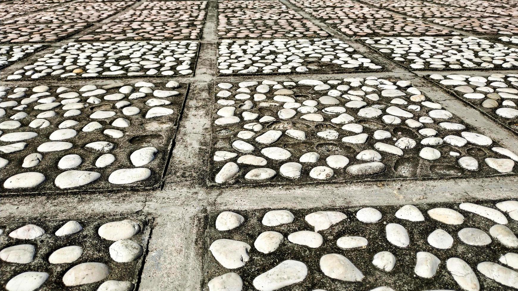 Floor motif of  natural stone paving blocks for your design concept.  Pattern background of floor. Paving block motif. Mosaic texture. photo