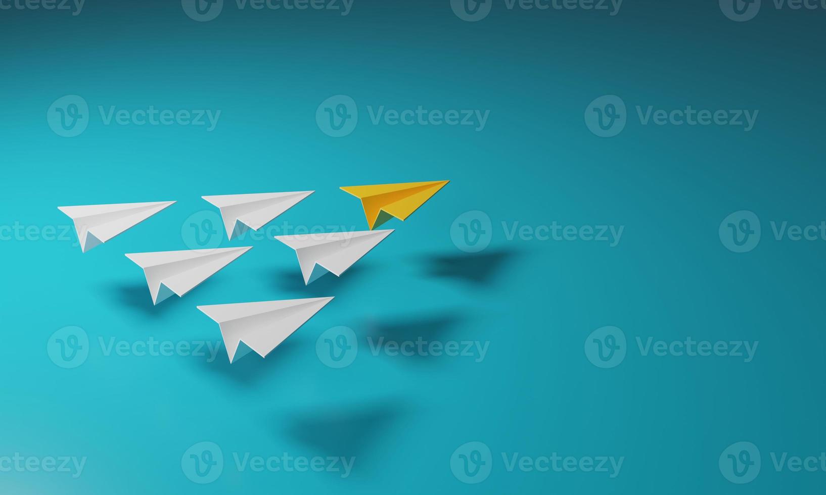 Yellow paper airplane leads a group of white planes. photo