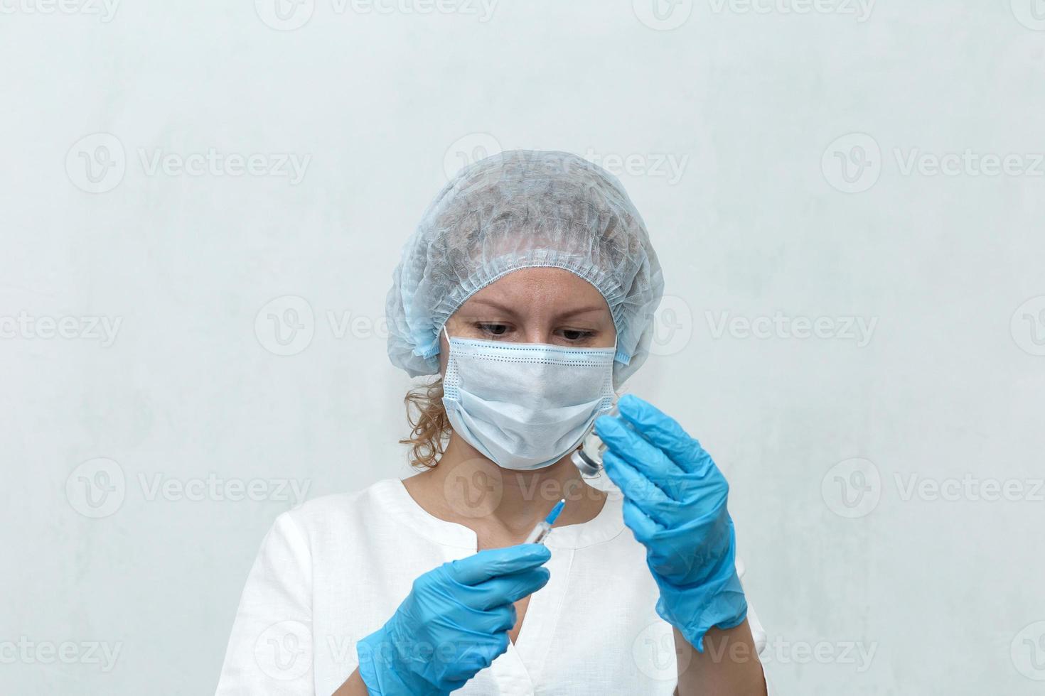 Nurse dials the injection into the syringe, vaccination photo