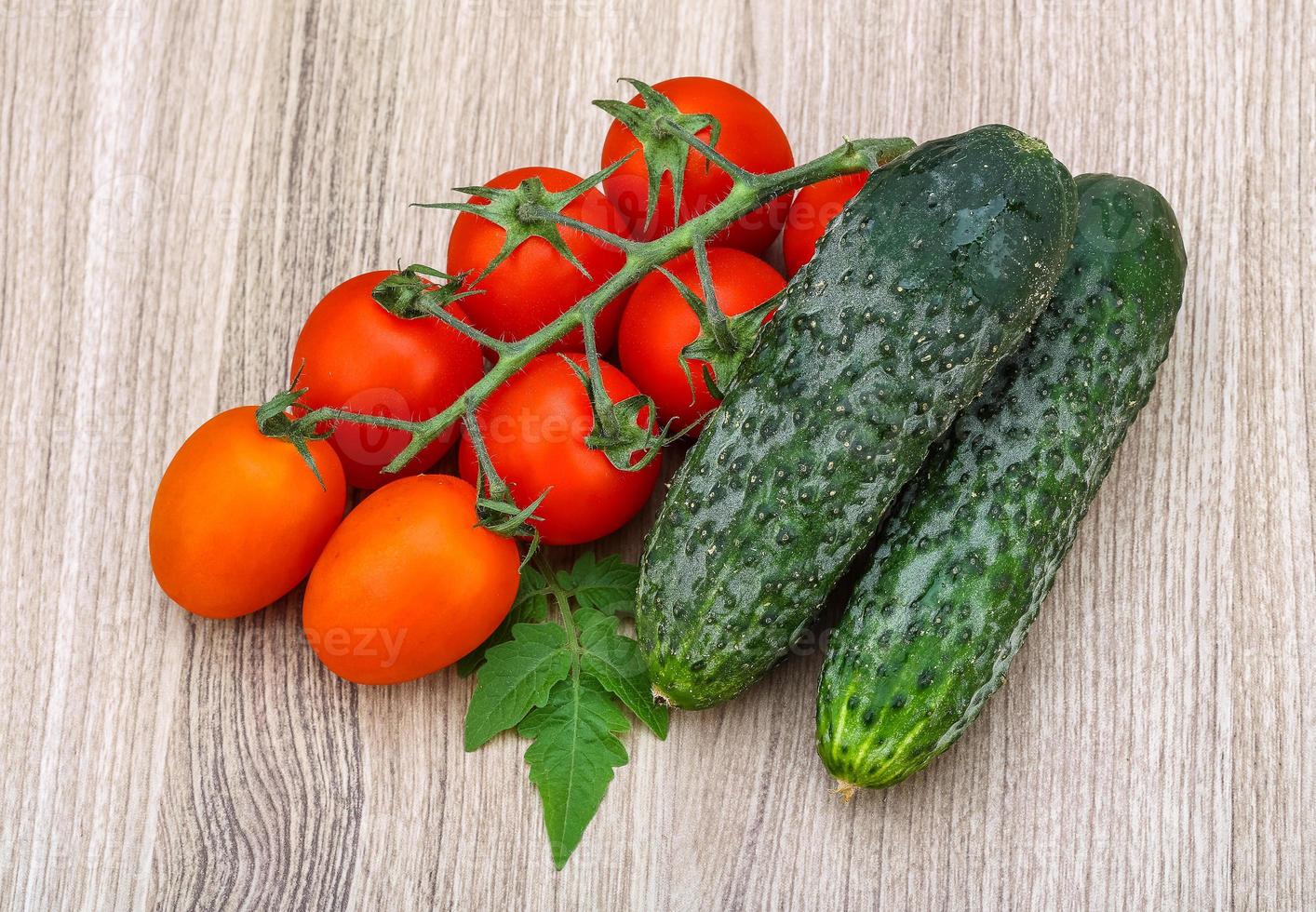 Cucumbers and tomatoes on the branch photo