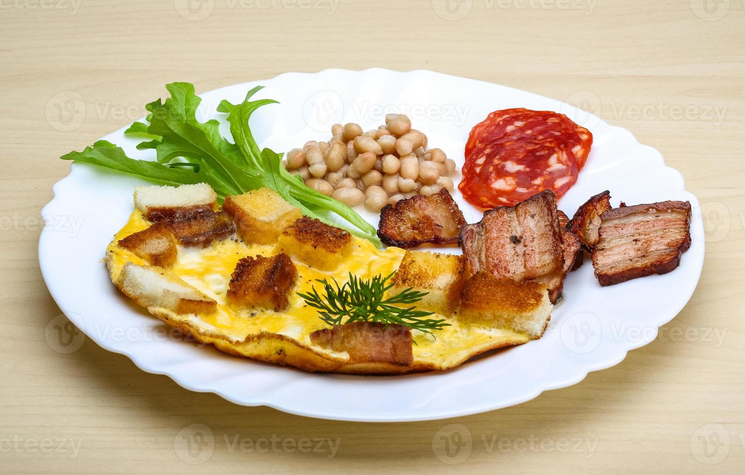 Breakfast with eggs, bacon and beans photo