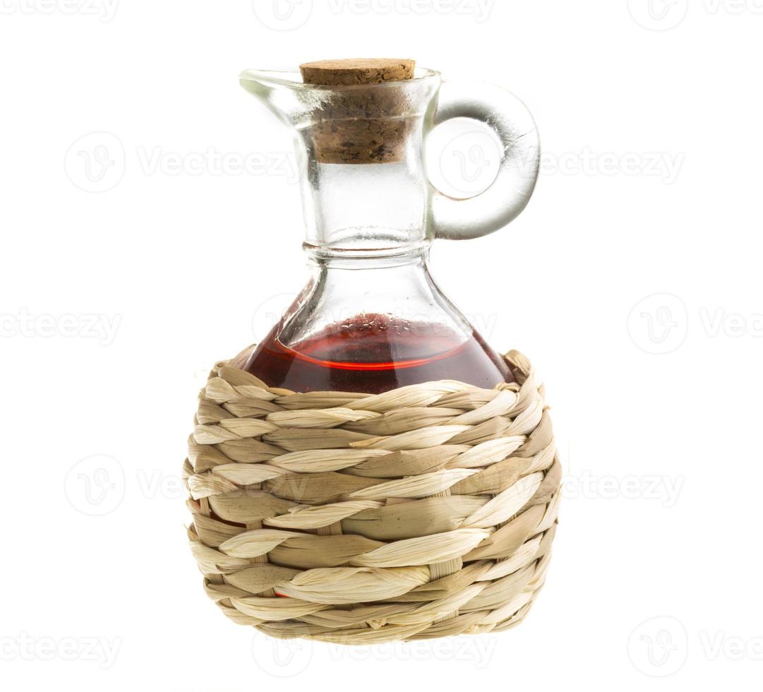 Small decanter with red wine vinegar isolated on the white photo