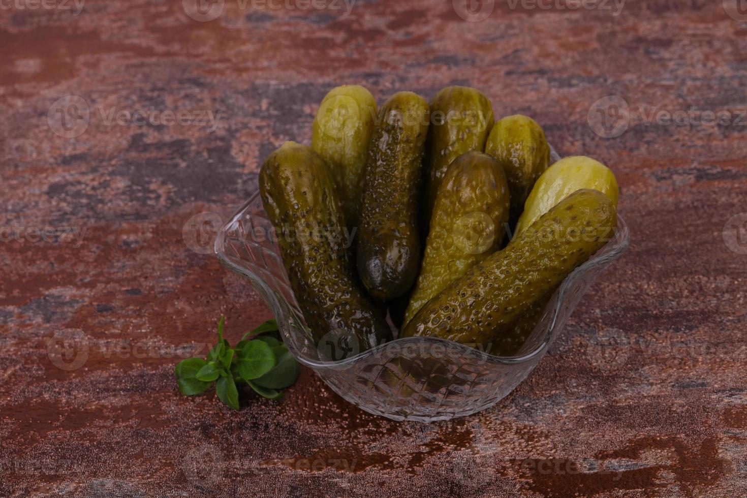 Pickled cucumbers heap in the bowl photo