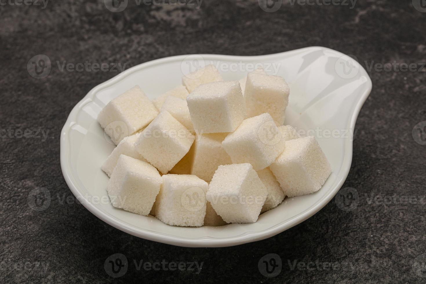 Refined white sugar cubs in the bowl photo