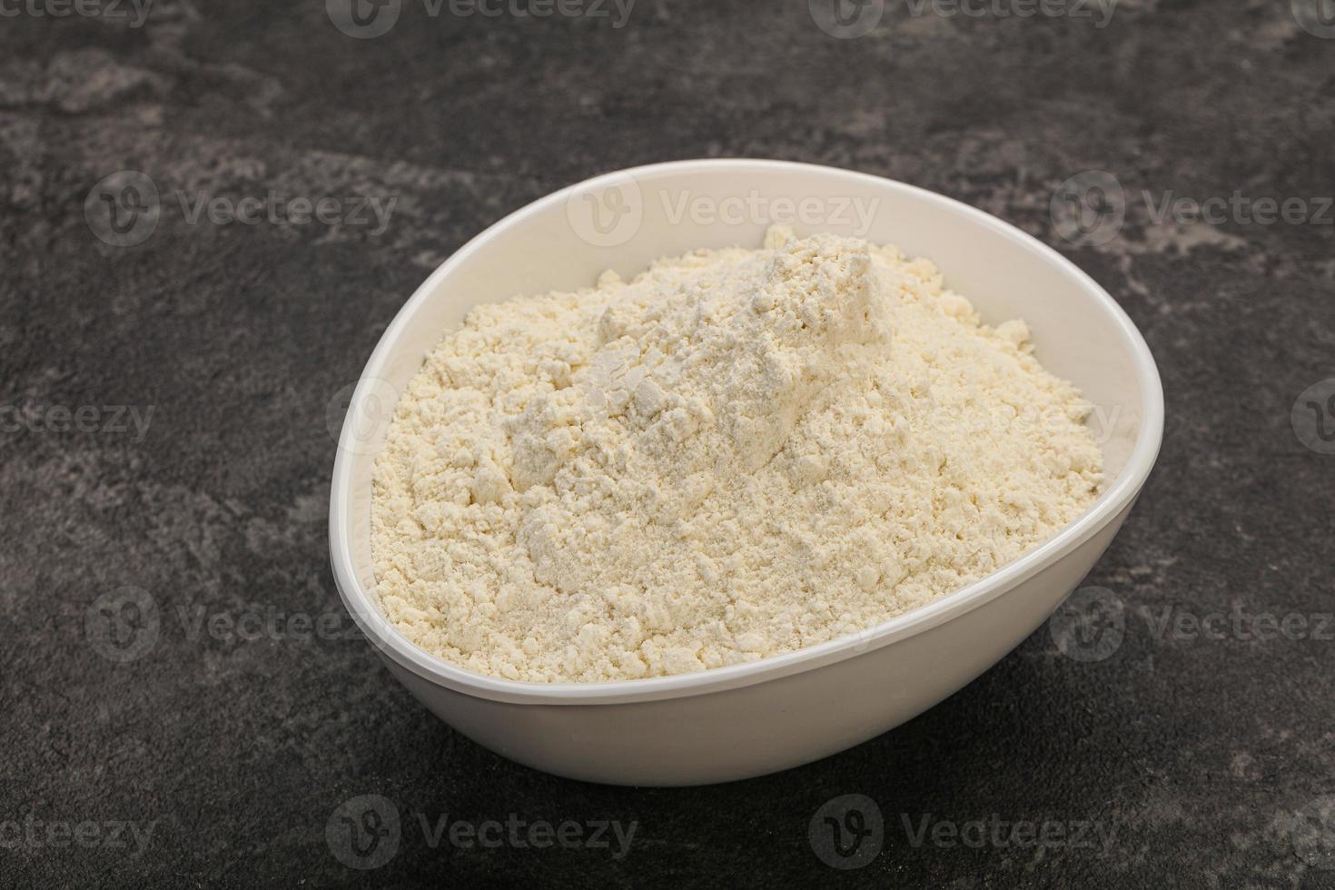 Wheat flour heap in the bowl photo