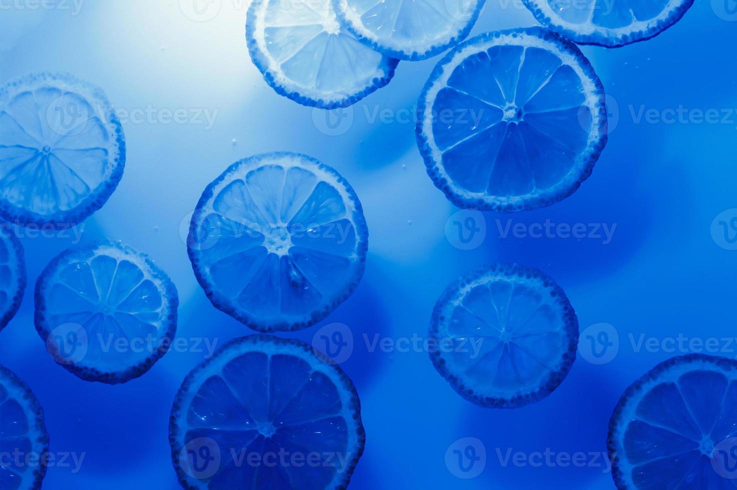 Abstract blue image of lemon slices. Blue lemon background. photo