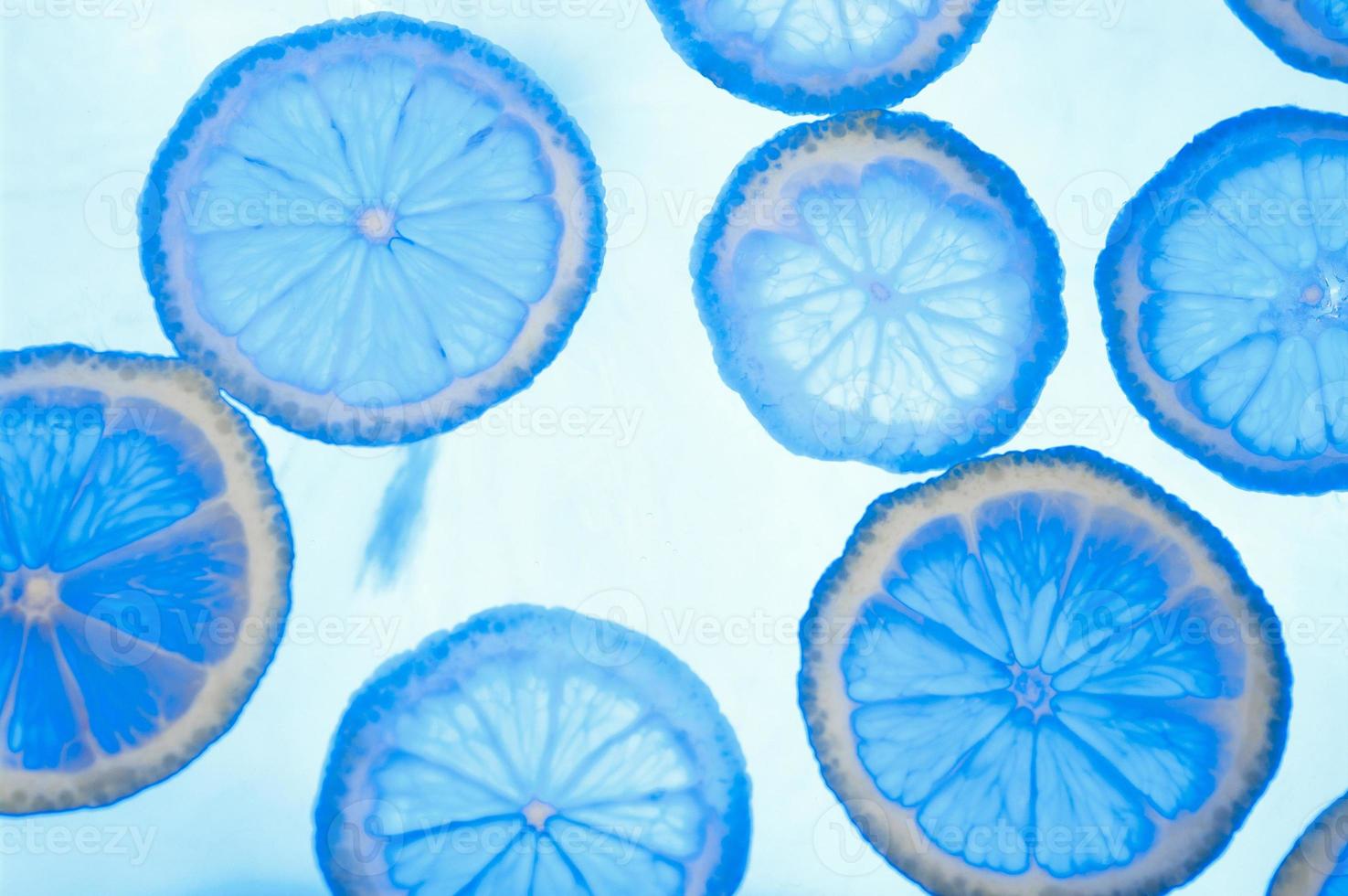 Abstract blue image of lemon slices. Blue lemon background. photo