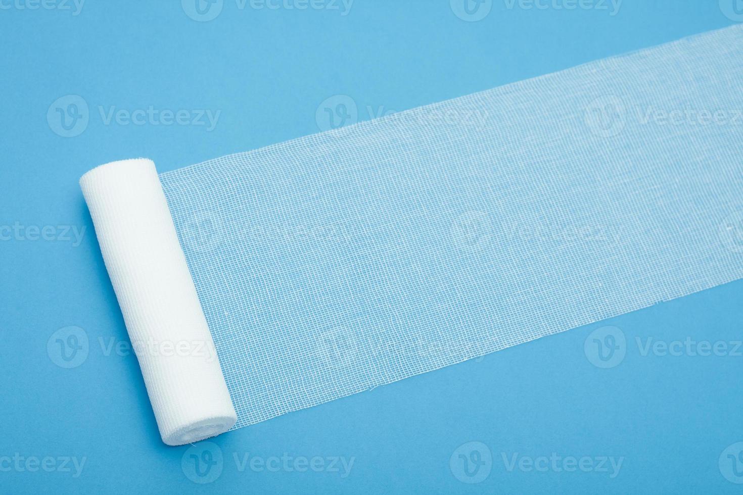 Medical sterile bandage on blue background. photo