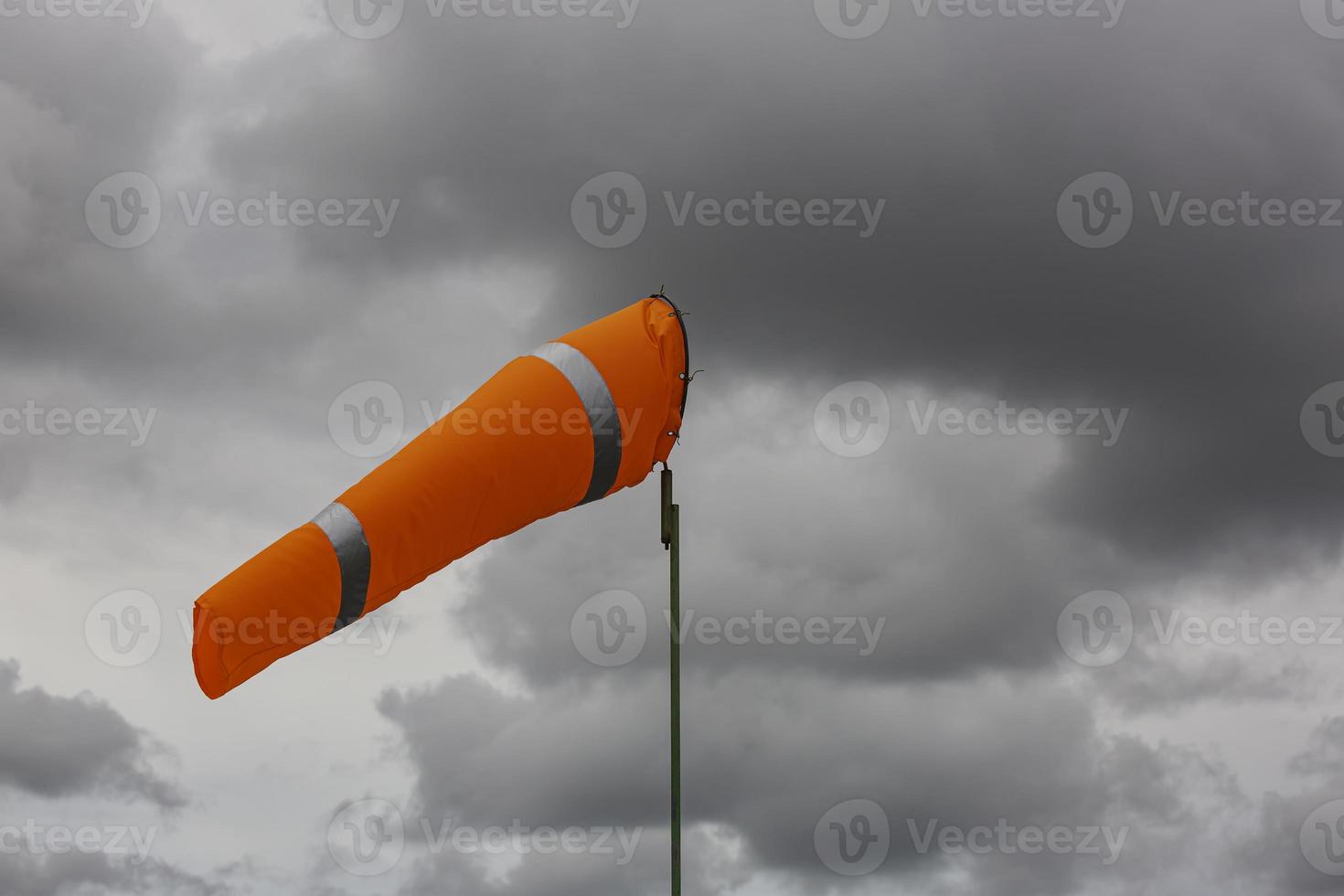 Windsock indicator of wind on tank chemical cone indicating wind direction and force. Horizontally flying windsock photo