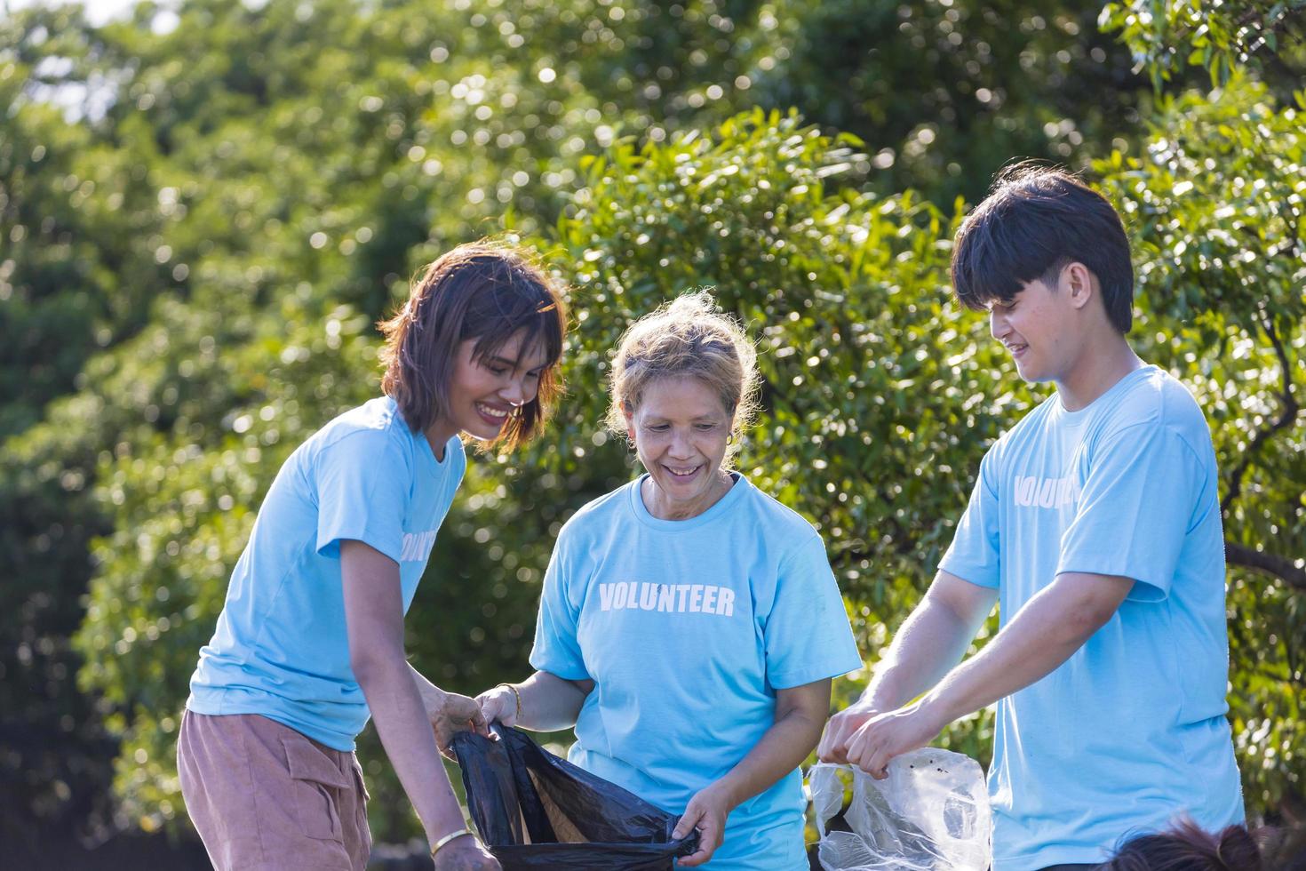 Team of young and diversity volunteer worker group enjoy charitable social work outdoor in cleaning up project in the countryside photo