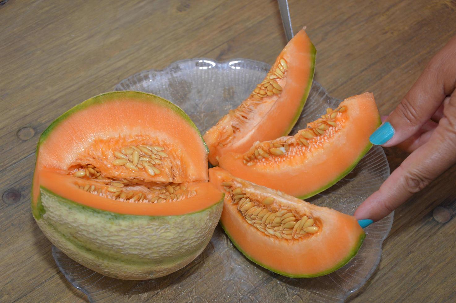 A Woman cut a melon photo