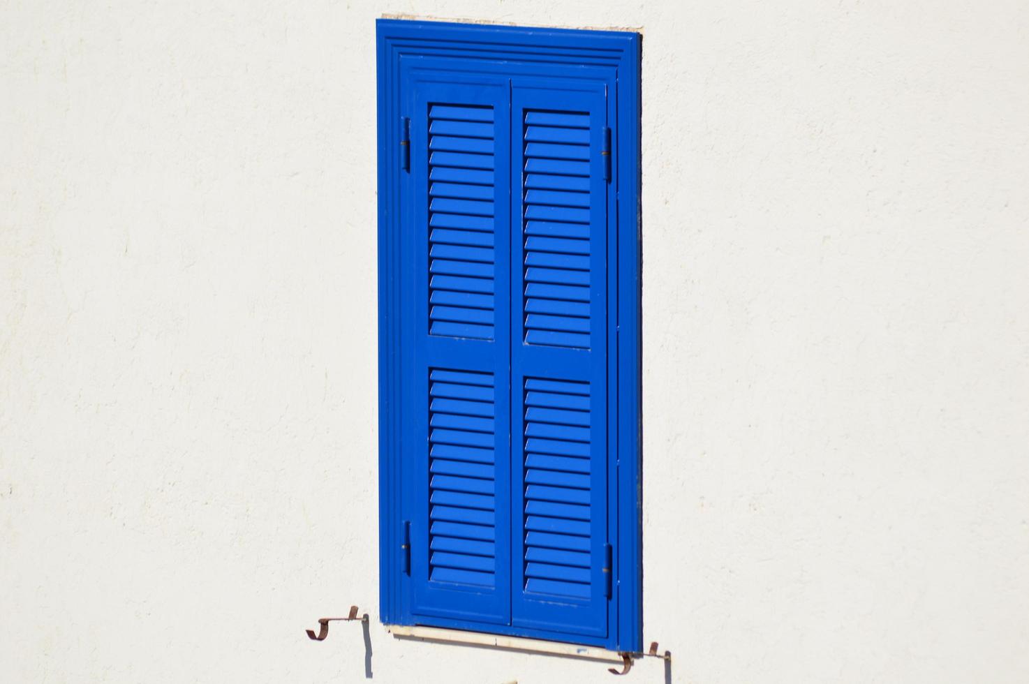 Blue shutter white wall photo