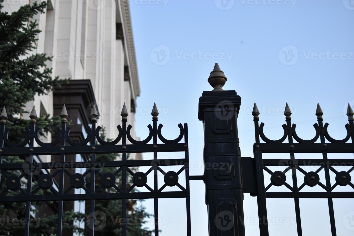 The iron fence of the government building in the park Russia. Iron pins on the fence. photo