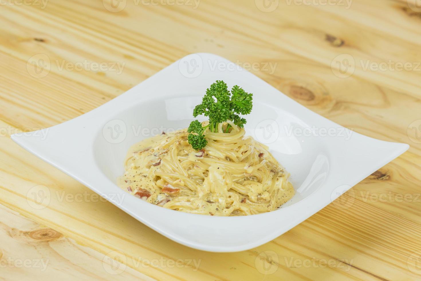 Classic homemade carbonara pasta with pancetta, egg, hard parmesan cheese and cream sauce. Italian cuisine. Spaghetti alla carbonara. photo