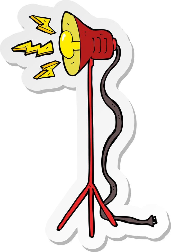 sticker of a cartoon studio lamp shining vector