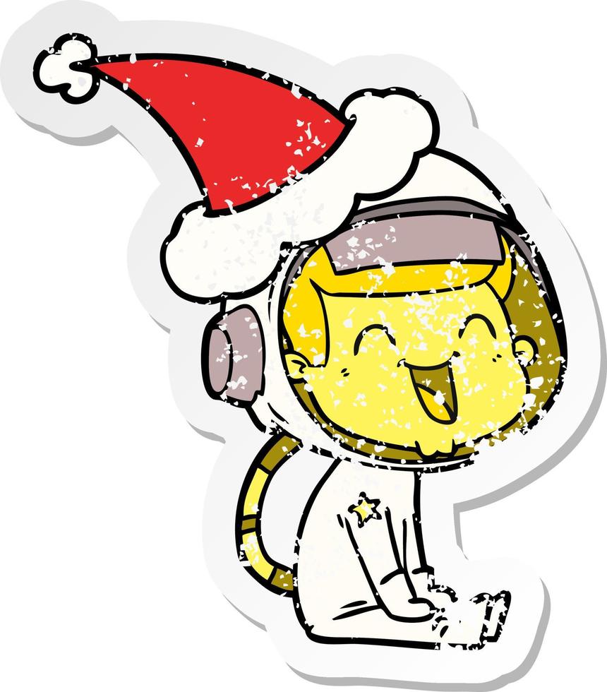 happy distressed sticker cartoon of a astronaut wearing santa hat vector