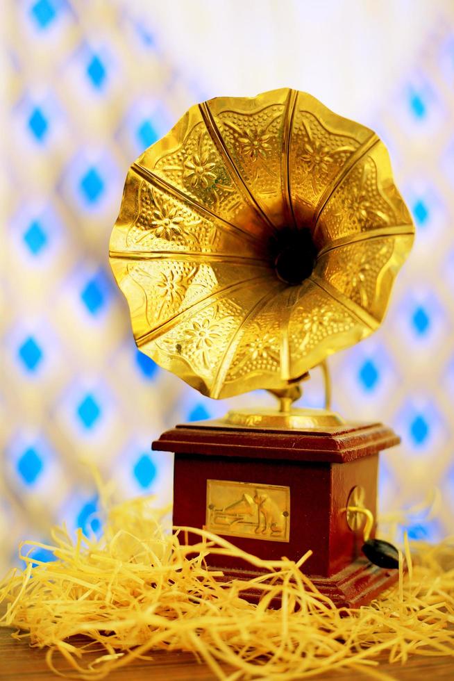Vertical shot of a small phonograph with golden details photo