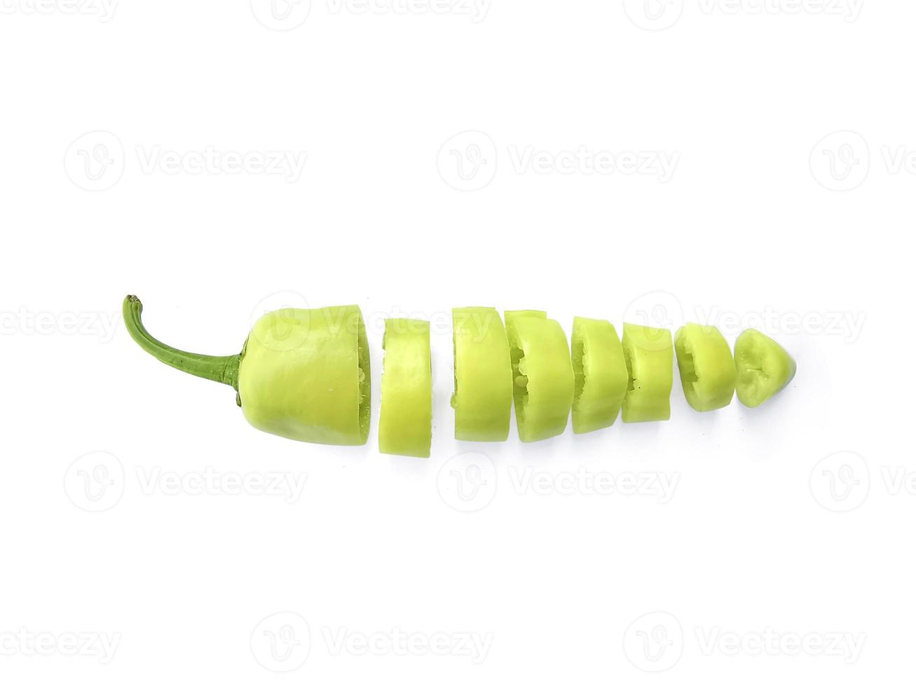 sliced green hot chili peppers isolated on white background photo