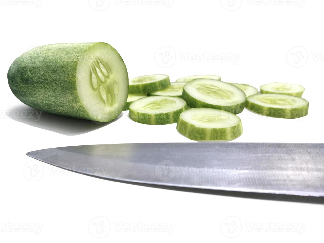 Cutting Fresh Green Cucumber isolated on white background photo