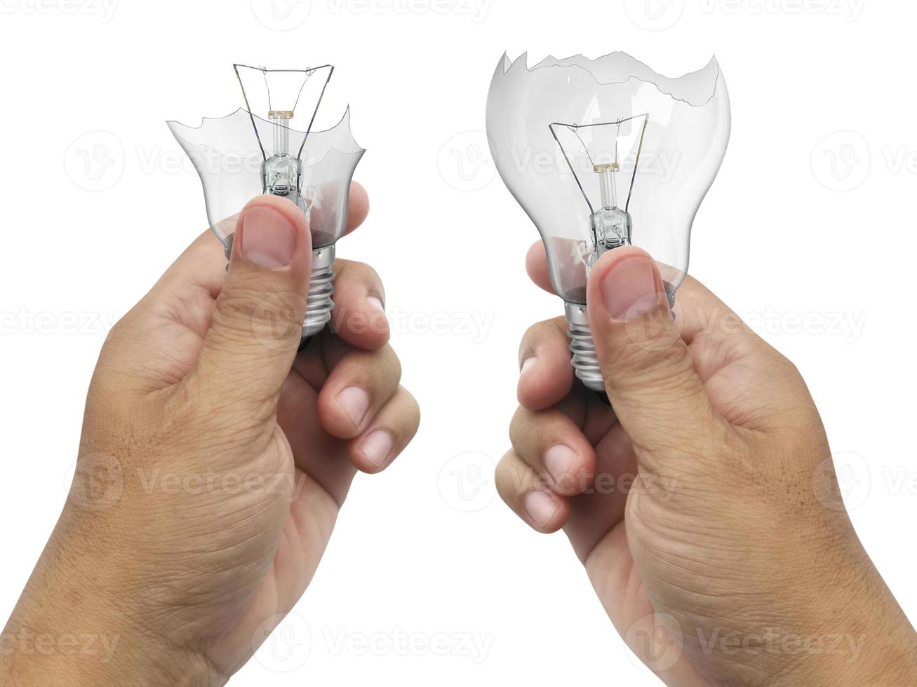 The broken bulb in a hand  Isolated on white background photo