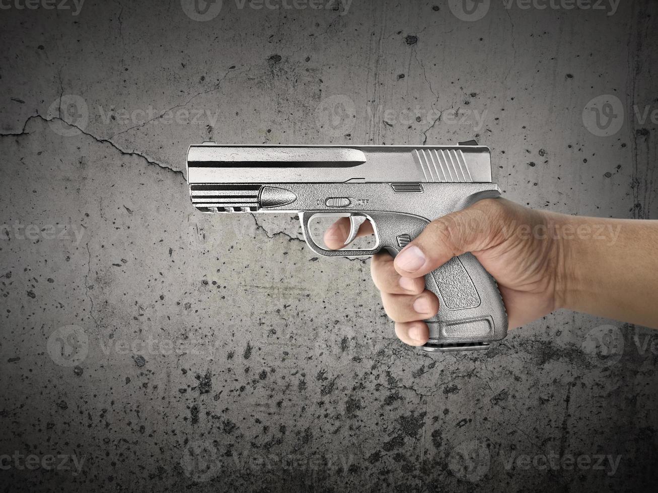 Killer with gun close up over grunge background with copyspace photo