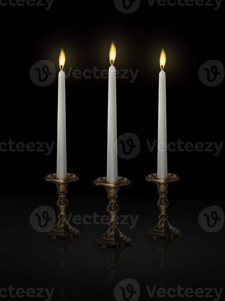 Candle light on a candlestick on a black background photo