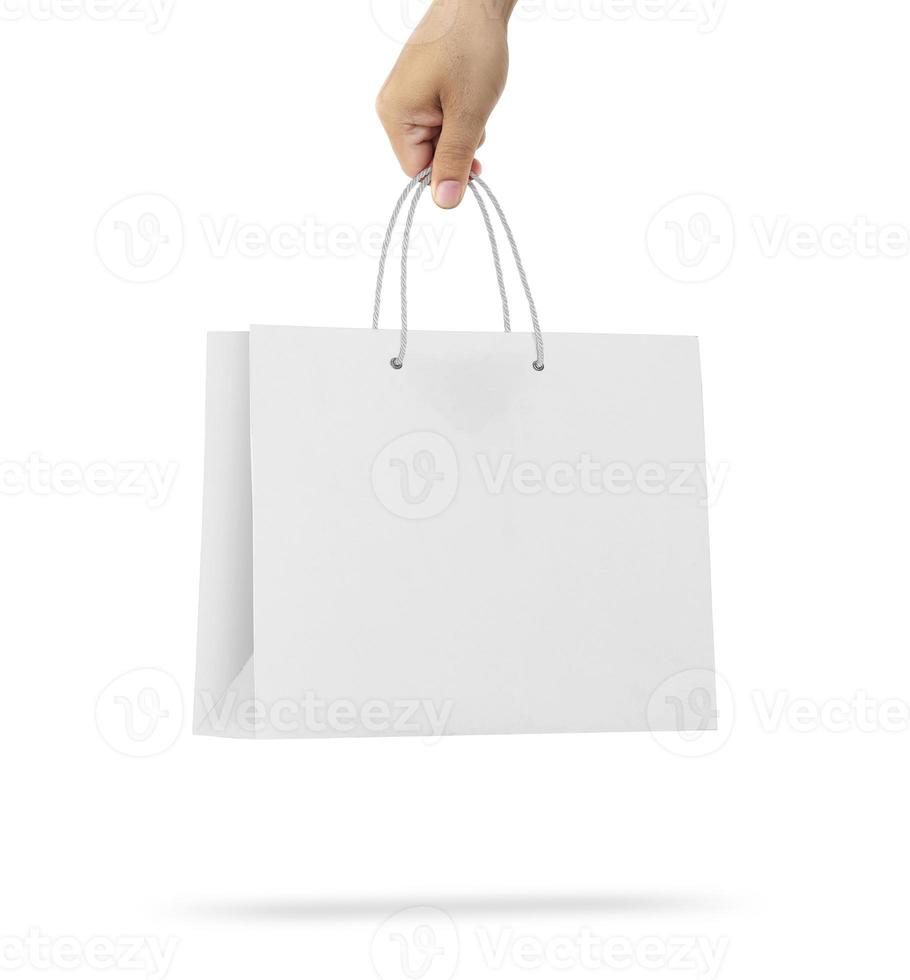 Hand holds a paper bag on a white background photo