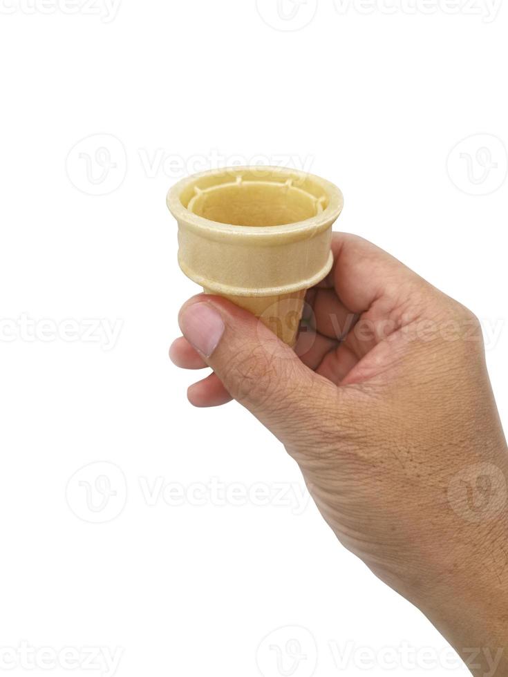 hand holding blank crispy ice cream cone isolated on white background photo