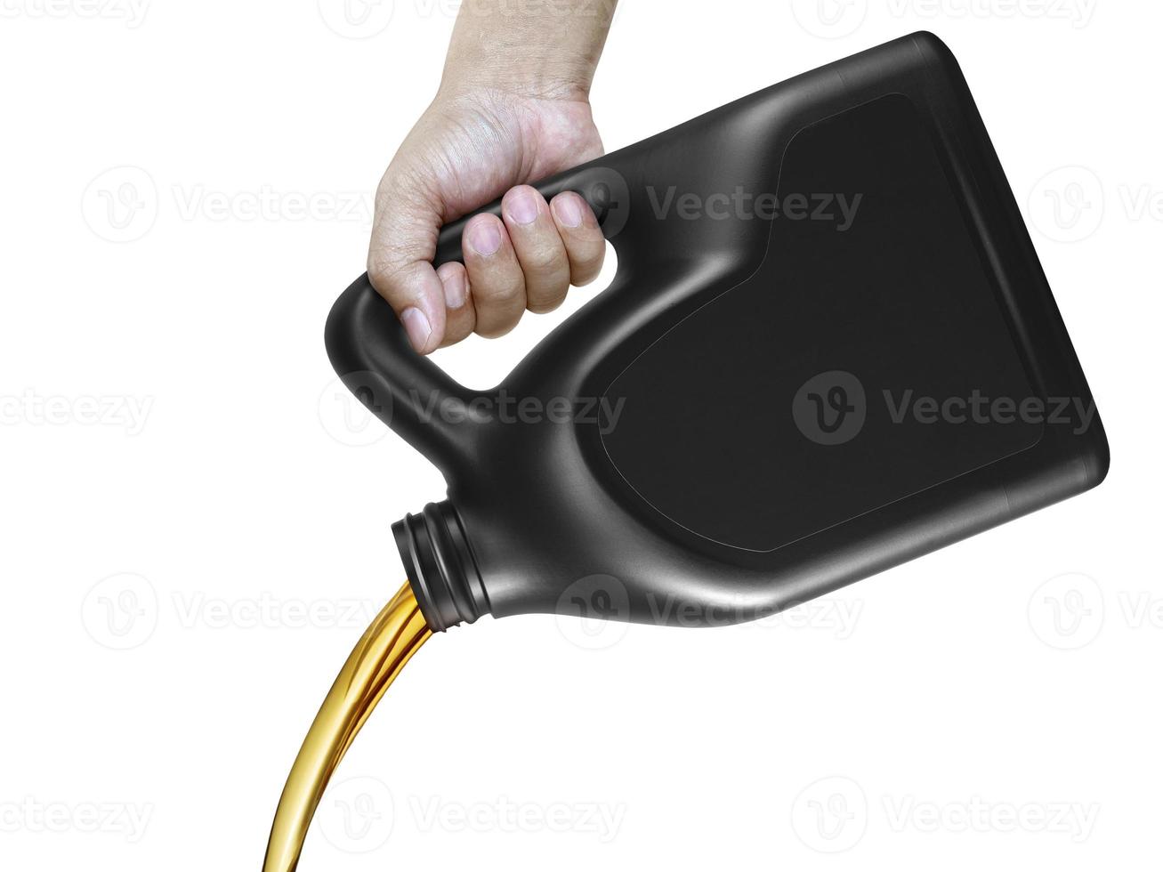 Engine oil pouring from a canister in hand isolated on white background photo