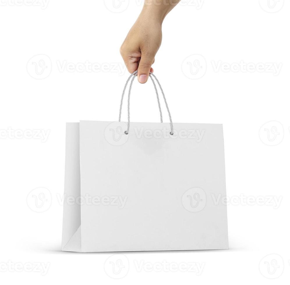 Hand holds a paper bag on a white background photo