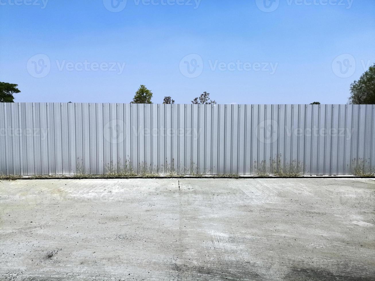 Aluminum fence against the sky. Texture of profiled metal. photo