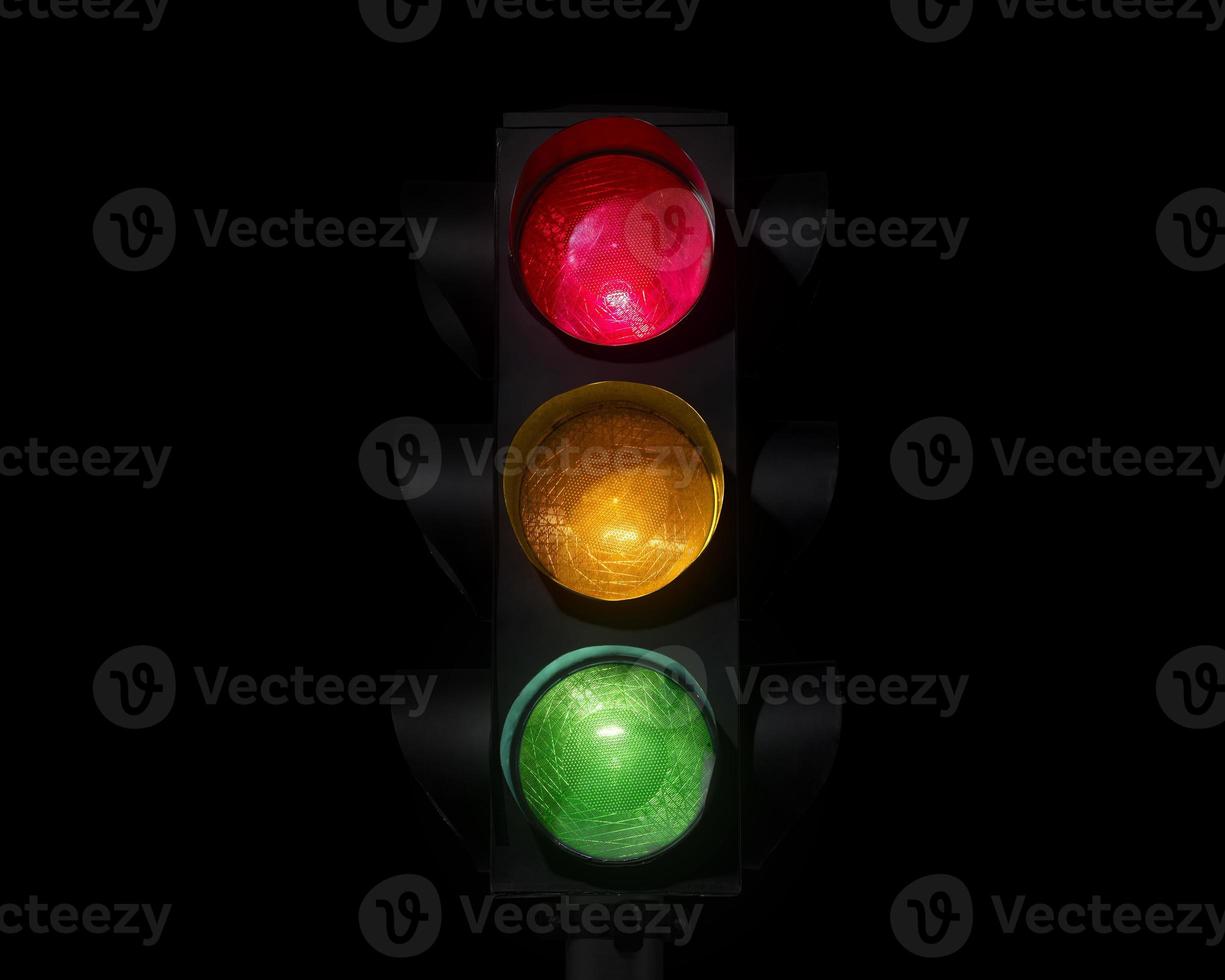 Traffic light on completely dark background photo