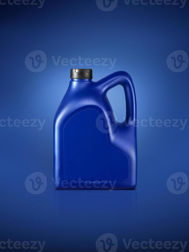 Gallon of engine oil on a dark blue background photo