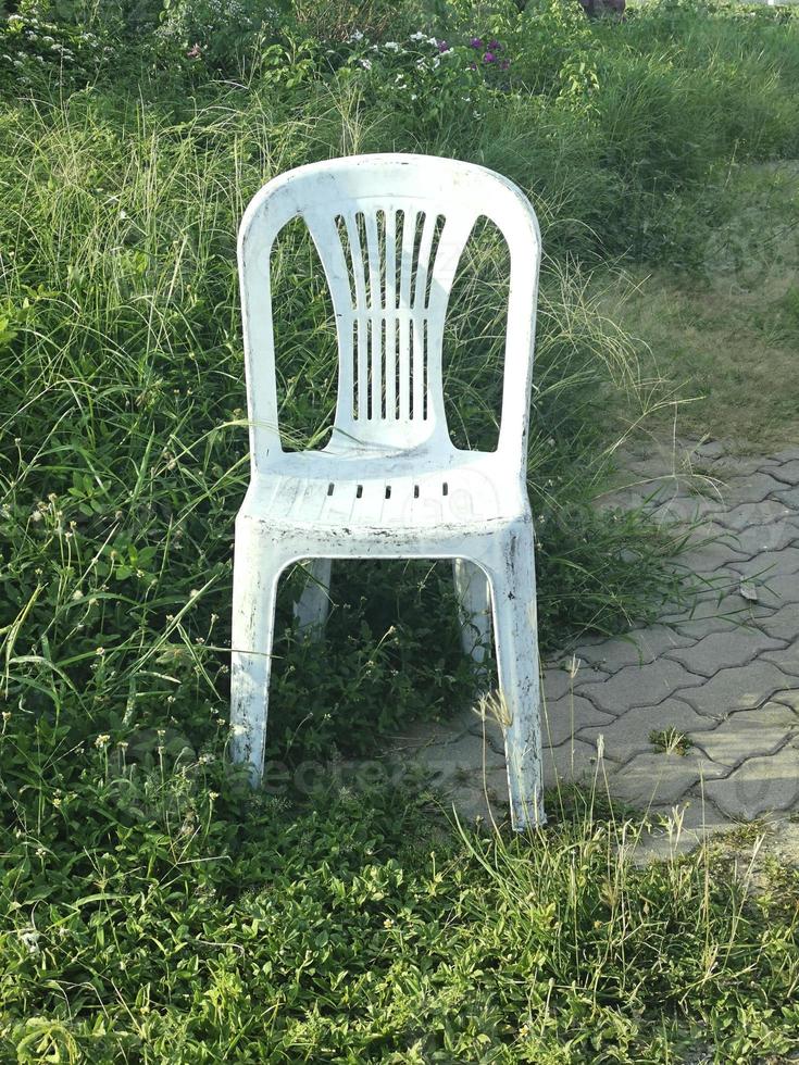 old plastic chair in the meadow photo