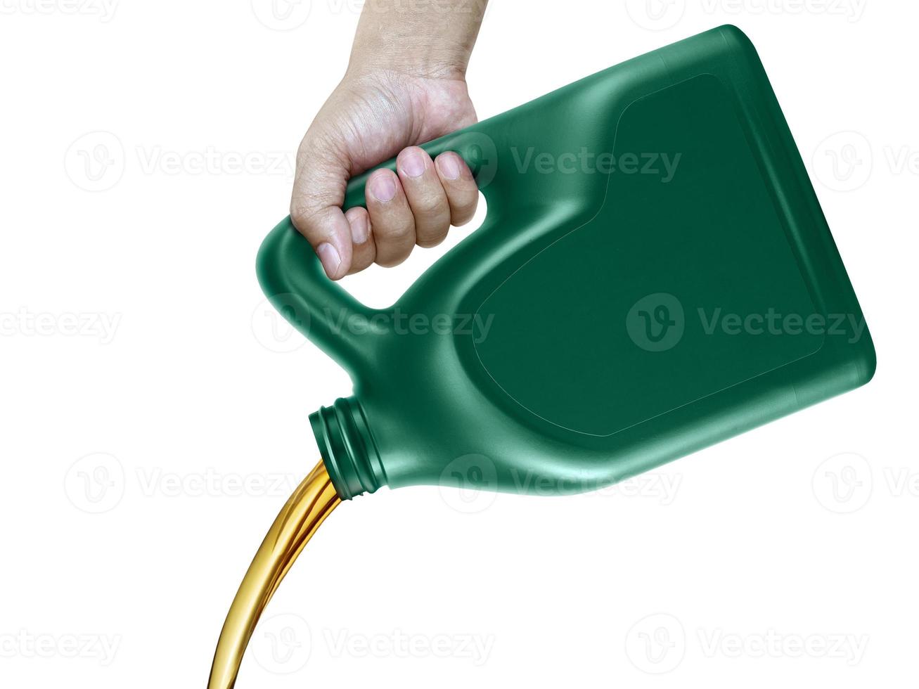 Engine oil pouring from a canister in hand isolated on white background photo