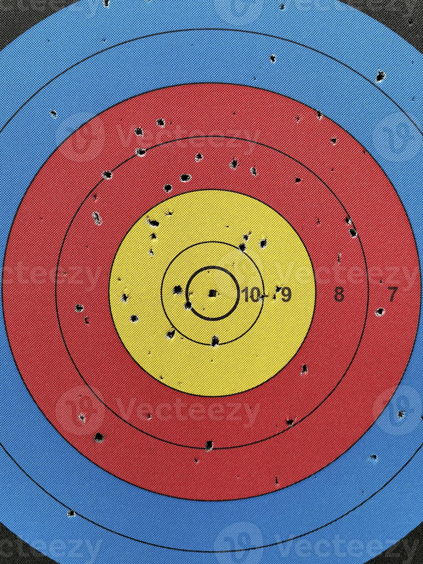 Numbered used dart board with number and full of dart holes 8616413