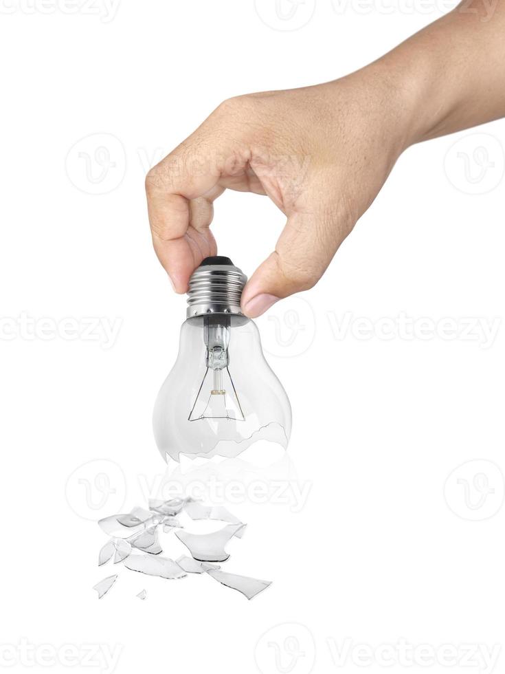 Hand holding Broken light bulb isolated on white background photo