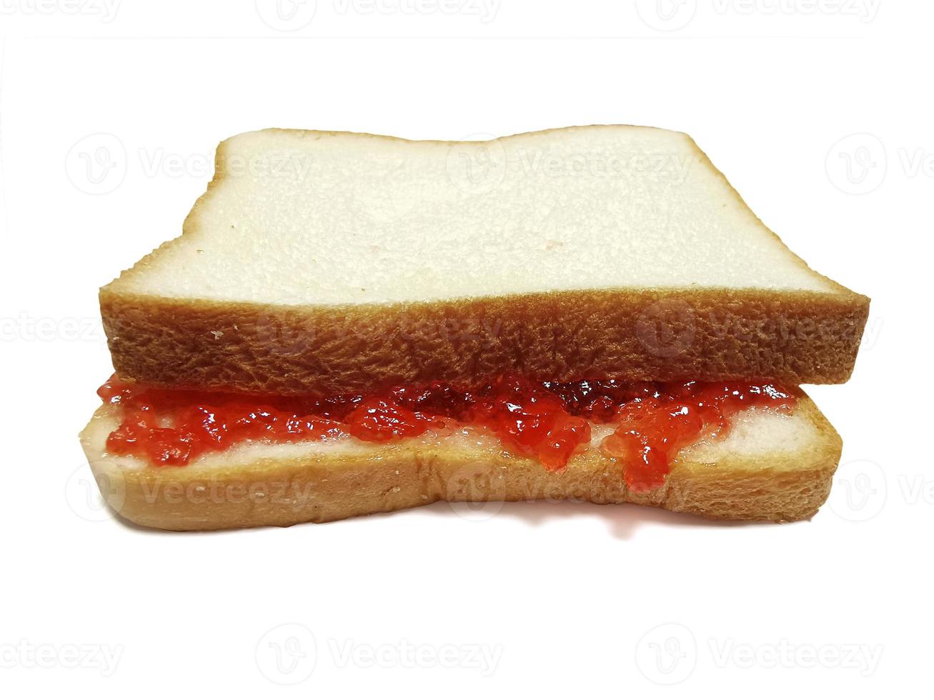 slice of bread with strawberry jam isolated on white photo