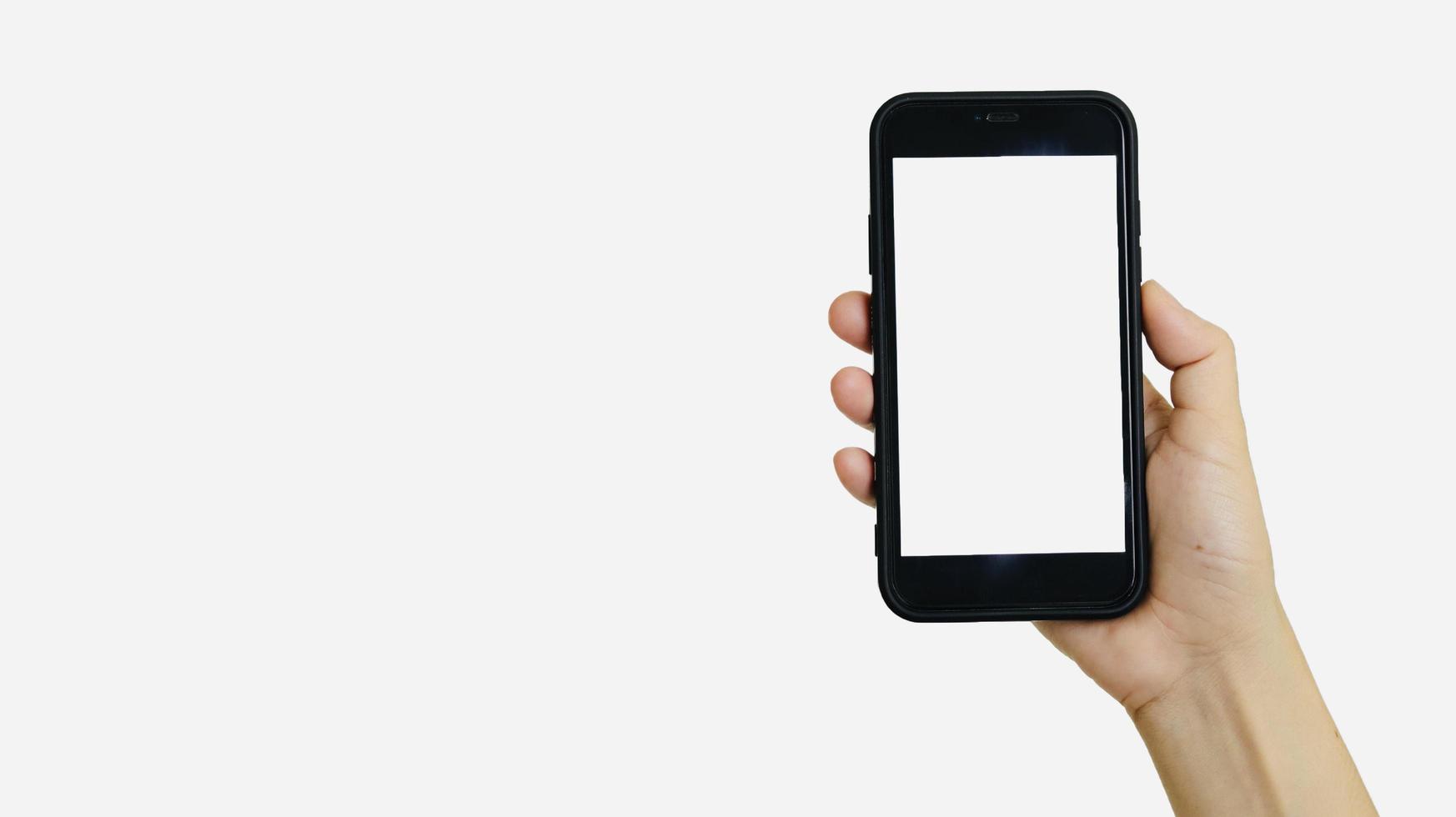 Hand holding smartphone on white background photo