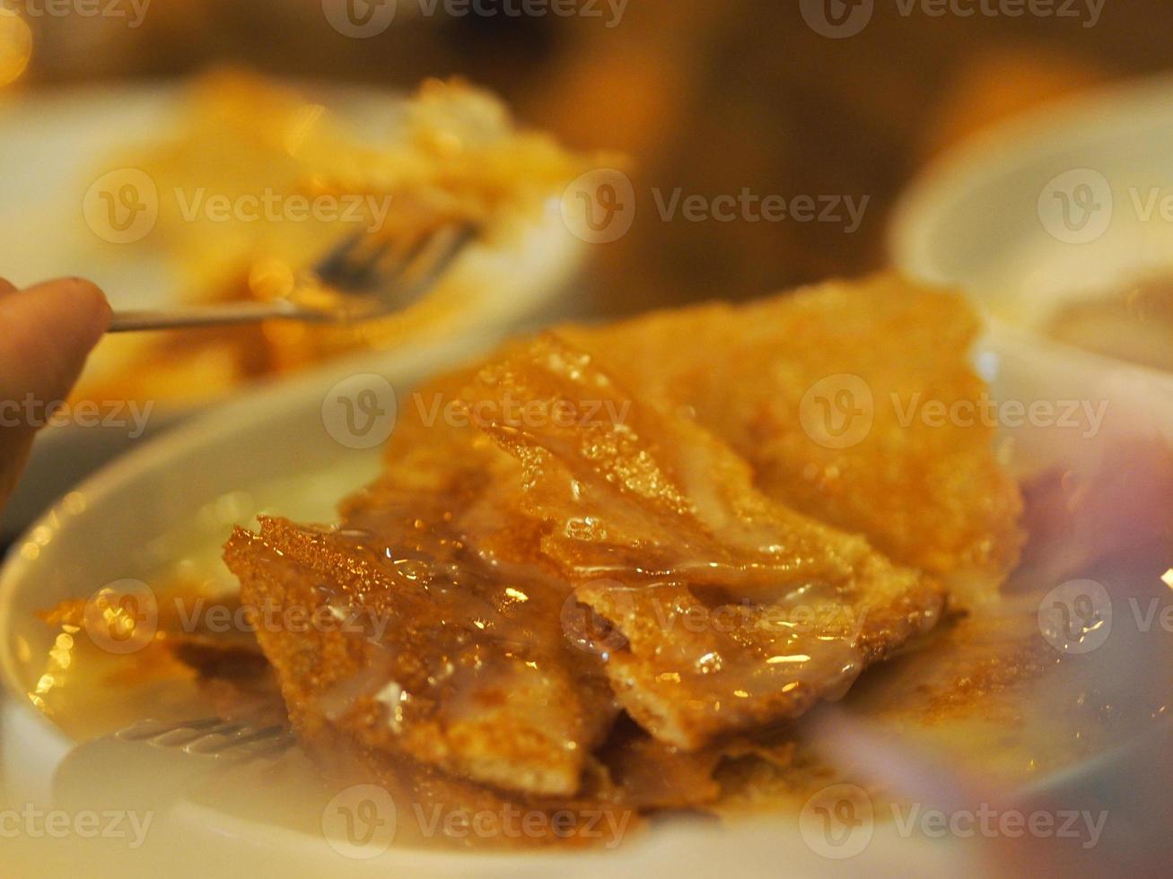 Crispy Roti with condensed milk in white dish, dessert snack sweet food photo