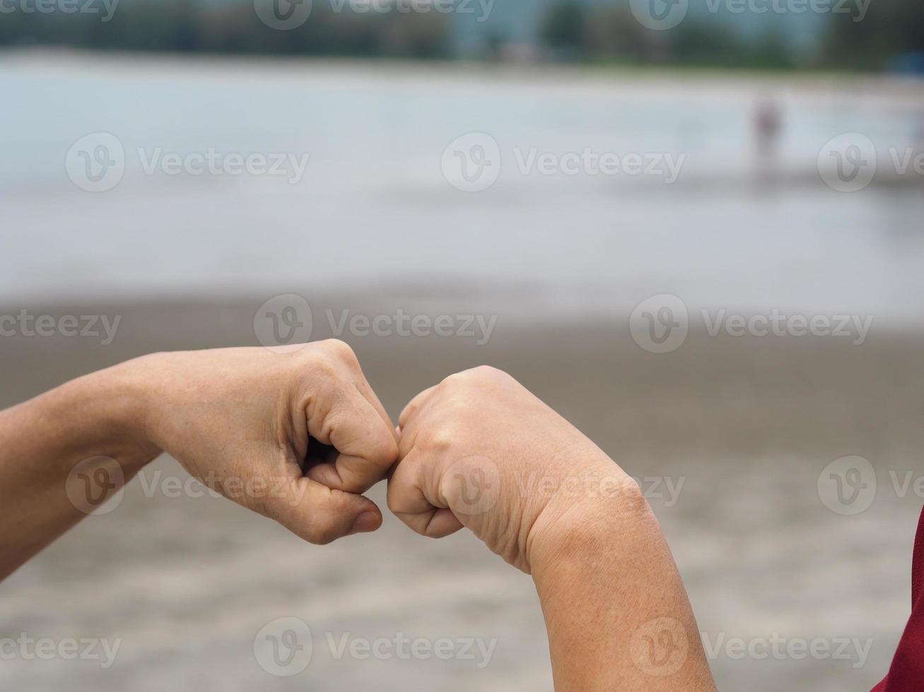 Two woman Alternative handshakes fist clenched hand greeting in the situation of an epidemic covid 19, coronavirus new normal social distancing photo