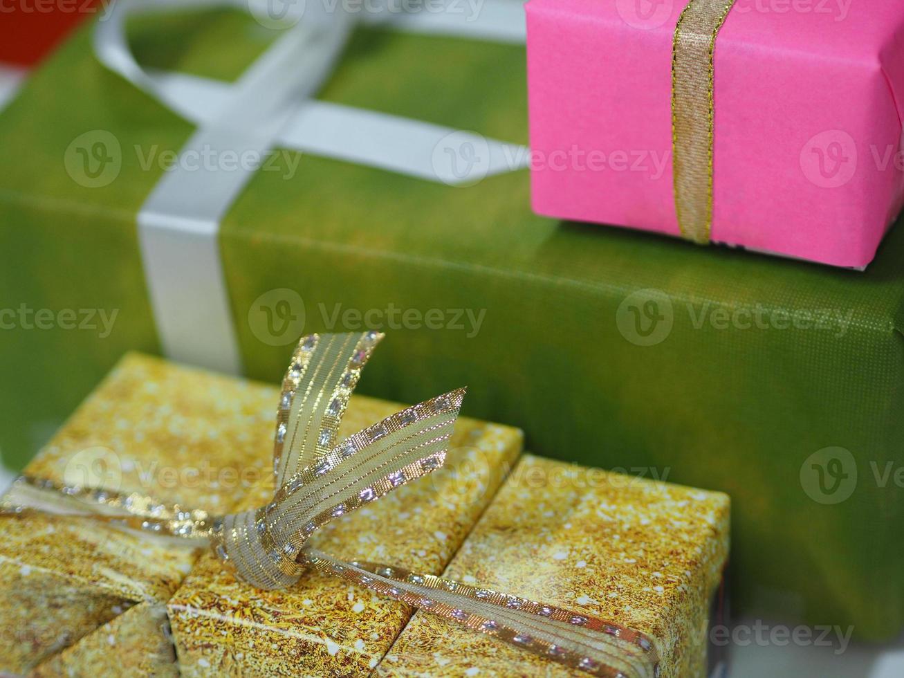 Stacked gift boxes wrapped in multi colored paper, Festival Gifts for Christmas and Happy New Year photo