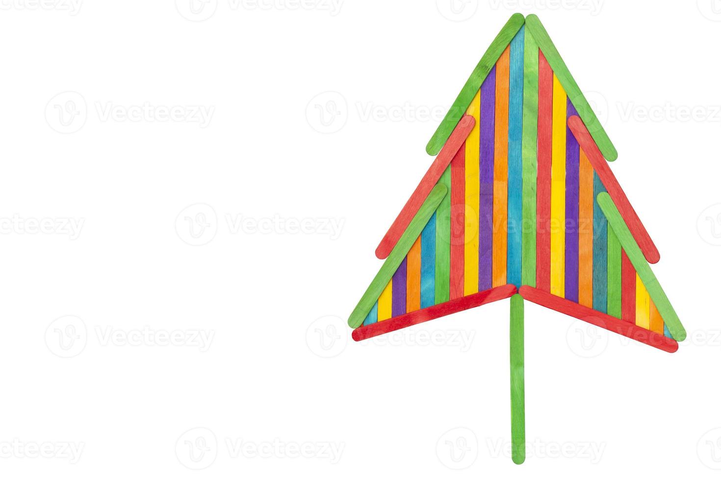 Connecting the colorful popsicle sticks joyfully is christmas tree isolated on white background included clipping path. photo
