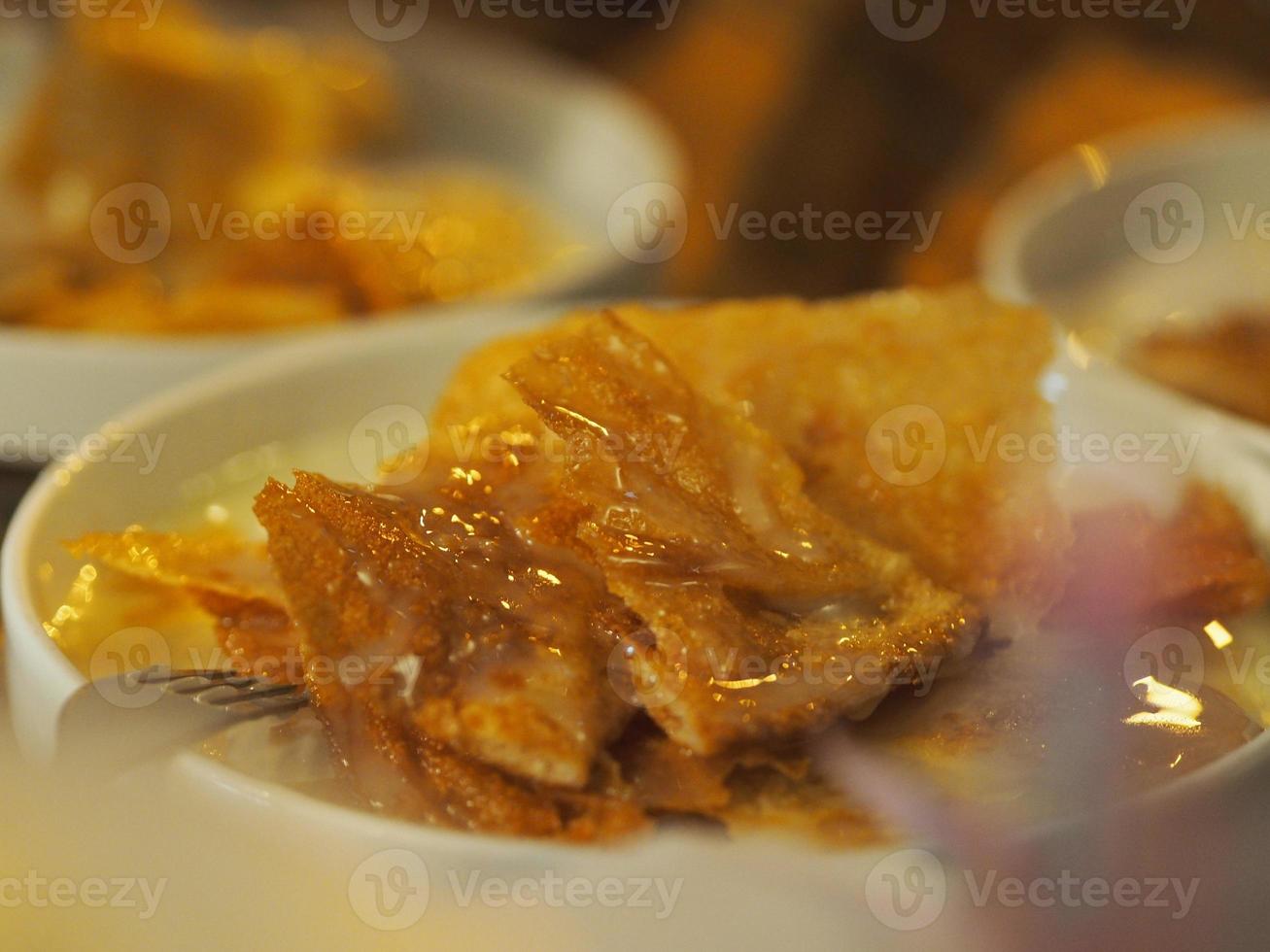 Crispy Roti with condensed milk in white dish, dessert snack sweet food photo